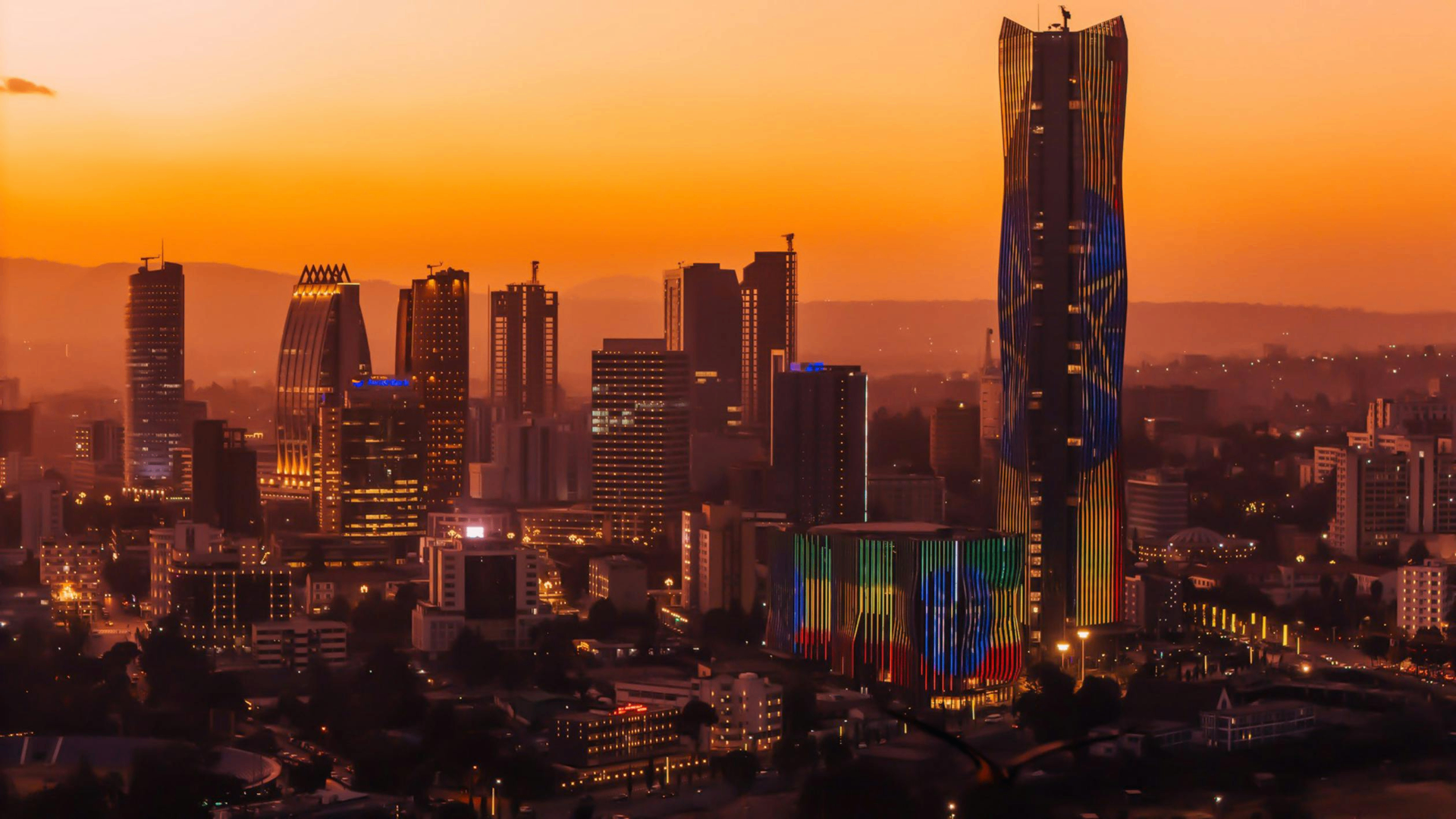 Addis Ababa skyline at sunset with the Ethiopian flag-lit tower